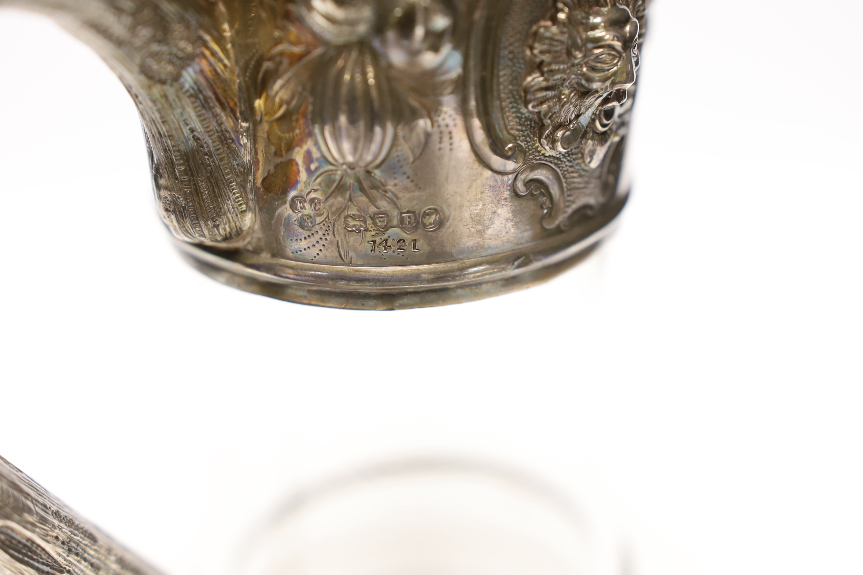 A late Victorian embossed silver mounted glass decanter, with rampant lion finial, Edward Charles Brown, London, 1877, 26.7cm.